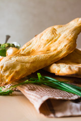 Georgian traditional bread - shoti. Puri made of white wheat flour in round clay oven. This bread is always on table with bunch of greens for Georgian lunch or dinner.