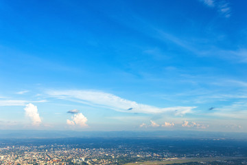 Blue background with white clouds sunset in the sky over city,evening cityscape.