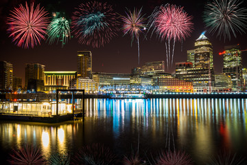 Canary Wharf business district at night with firework, celebration of the New Year in London, UK