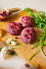 Pkhali balls - traditional Georgian food of chopped vegetables. Made of cabbage, beetroot, eggplant, spinach, beans, walnuts, adjika, vinegar, onions, garlic, and herbs. Garnished pomegranate kernels.