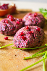Pkhali balls - traditional Georgian food of chopped vegetables. Made of cabbage, beetroot, eggplant, spinach, beans, walnuts, adjika, vinegar, onions, garlic, and herbs. Garnished pomegranate kernels.