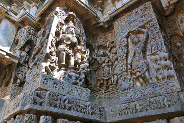 Ornate wall panel reliefs depicting Goddess Kali on the left and Govardhan Girdhari on the right, Hoysaleshwara temple, Halebidu, Karnataka