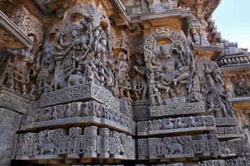 Ornate wall panel reliefs depicting Goddess Mahishasurmardini on the left and Narsimha on the right, Hoysaleshwara temple, Halebidu, Karnataka