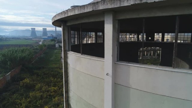 Slow aerial drone flight revealing deteriorated power plant and Communist era industrial zone in Albania, Europe
