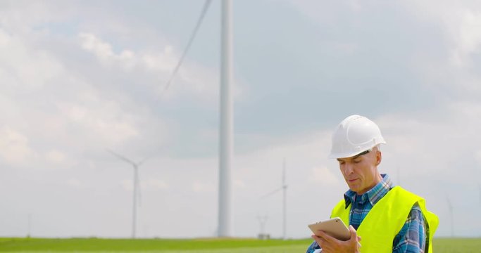 Engineer using digital tablet when doing Wind Turbine Inspection