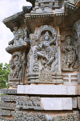 Ornate wall panel reliefs depicting Krishna dancing on the head of serpant Kalia and eventually killing him. Kedareshwara temple, Halebidu, Karnataka