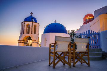 Beautiful sunset view of blue domes of Oia in Santorini island, Greece 