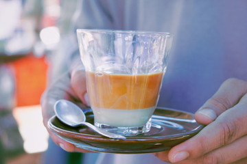 Hands of young man served with hot tea Selective focus.