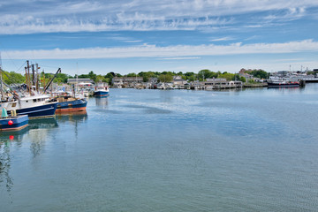 Fototapeta na wymiar boats sit quietly in a harbor in Cape Cod