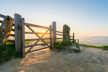 The Great Ridge of Mam Tor hill with sunrise flare.Peak District. England