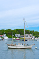 Fototapeta na wymiar A sailboat is moored in the harbor in Hyannis on a summer day