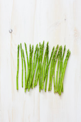 Fresh asparagus on white wood background