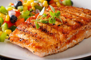 Grilled salmon fillet with salsa of corn, blueberries and pepper macro. horizontal
