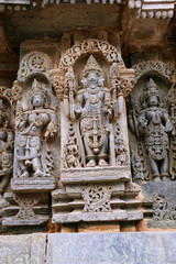 Fototapeta na wymiar Ornate wall panel reliefs depicting lord Brahma in the centre and other deities, North wall, Kedareshwara temple, Halebidu, Karnataka