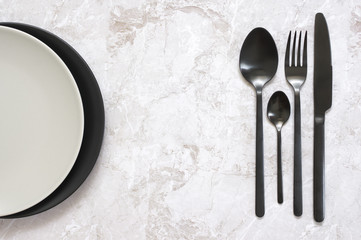 Black and white tableware on marble