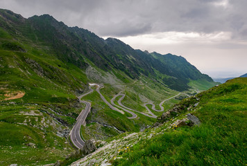 winding serpentine of the TransFagarasan road. beautiful transportation background. popular tourist...