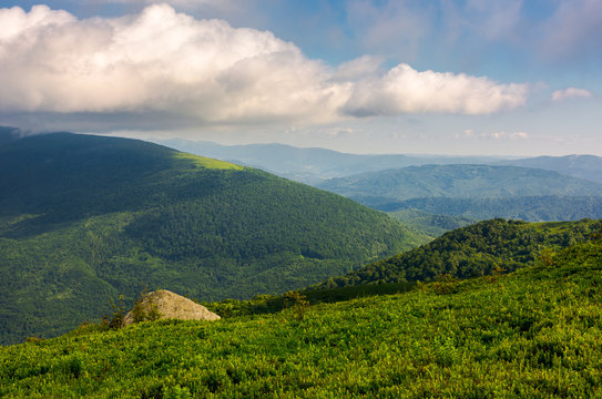 green hill of polonina Runa in summer. Fine weather with some clouds on a blue sky in mountainous landscape of Carpathian region