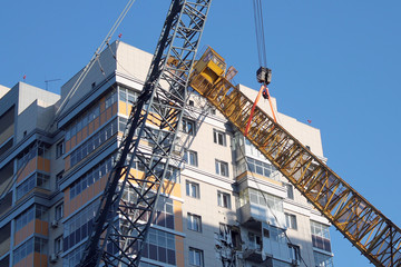 Fototapeta na wymiar the crane fell to a high-rise building