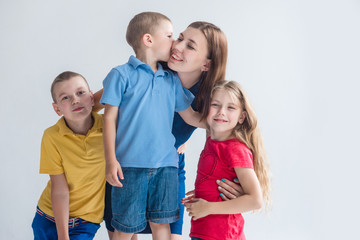 Mother and her three kids on white background