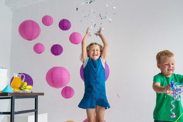 Children birthday party. Play with balloons and confetti