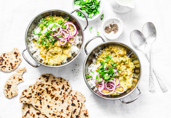 Indian dhal with jasmine rice, marinated red onion, scallion and whole grain flatbread on light background, top view. Flat lay, vegetarian food concept