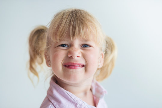 Little happy girl portrait on white background