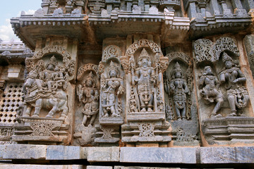 Ornate wall panel reliefs depicting Shiva-Parvati on the left, Brahma in the centre and other deities, North wall, Kedareshwara temple, Halebidu, Karnataka