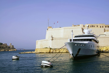 Luxury yacht and medieval Fort San Angelo