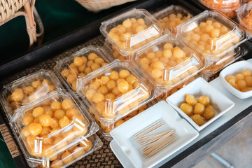 Thai style desserts in plastic boxes.