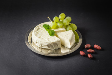 Camembert on the Plate with Grape, Peanuts and Mint
