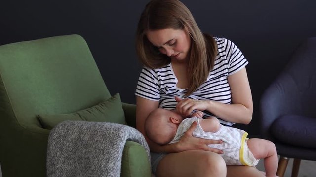 Newborn baby being breastfed by mother