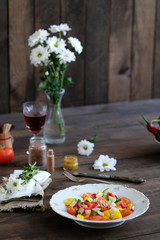  wine, flowers and salad from vegetables on old wooden table