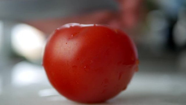 Close Image Man in Kitchen Cut a Red and Juicy Red Tomatoesd