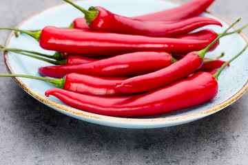 Chili cayenne pepper on grey background.