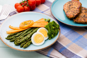 Fried asparagus with broccoli and lemon and carrot.