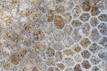 Fototapeta premium Medieval french stone building wall fasade hive shaped stones in concrete. Background for backdrop.