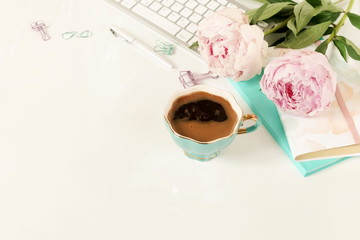 Flat lay women's office desk. Female workspace with laptop,  flowers peonies,  accessories,...