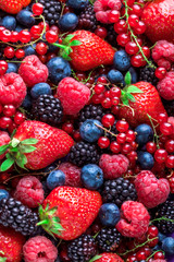 Fototapeta premium Berries fresh colorful overhead assortment strawberries blackberries red currant raspberries in studio