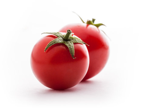 Tomatoes fresh colorful closeup vibrant color front view arrangement lined up on white background in stdio