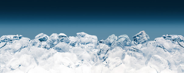 Pieces of crushed ice cubes on blue background. Clipping path included.