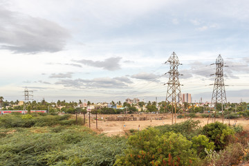 Electricity power substation in chennai india, where electrical power is generated, transmitted, and distributed to systems. Photographed during sunset with low lighting conditions, dark clouds in sky