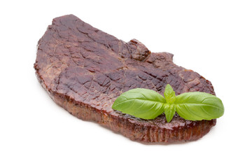 Grilled beef steaks with spices isolated on white background.