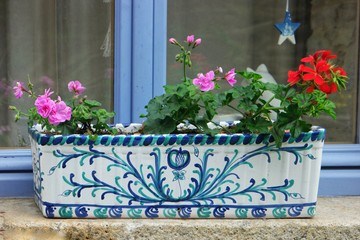 May 28, 2018 Saint-Malo, France Decorative ceramic flower pot on the window in the street