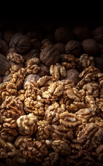 Walnuts large arrangement overhead in kernel and peel on dark background in studio