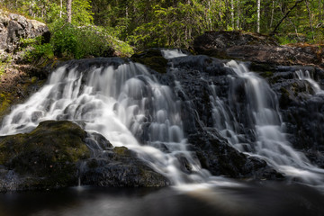 Fototapeta na wymiar The waterfall of Liejeenjoki in Puolanka, Finland.
