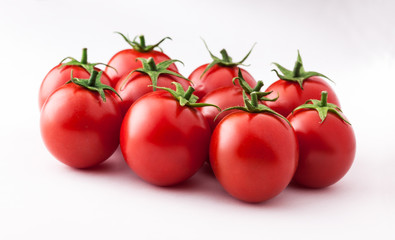 Tomatoes fresh colorful arrangement lined up isolated on white background in studio