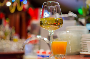 Glass white wine on a wooden table in cafe bar