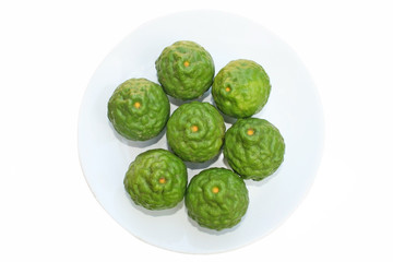 Kaffir lime or bergamot in white dish isolated on white background  top view