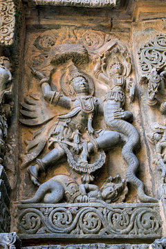 Sculpture depicting Garuda vehicle of lord Vishnu fighting with the snakes in the centre, west side, Hoysaleshwara temple, Halebidu, Karnataka