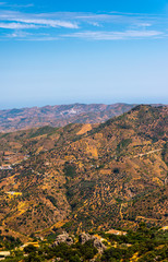 Fototapeta premium beautiful view of the mountains in the region of Andalusia, houses and farmland on the slopes of mountains